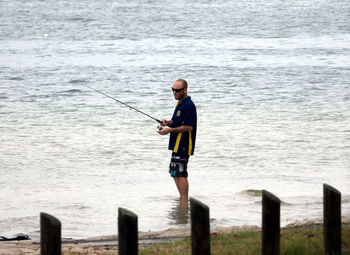 Full length of a man fishing in sea