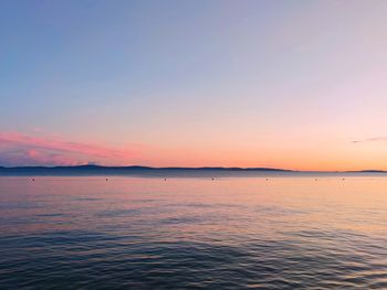 Scenic view of sea against clear sky during sunset