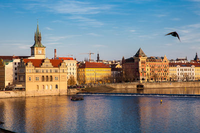 Boat navigating on vlava river at sunset in prague