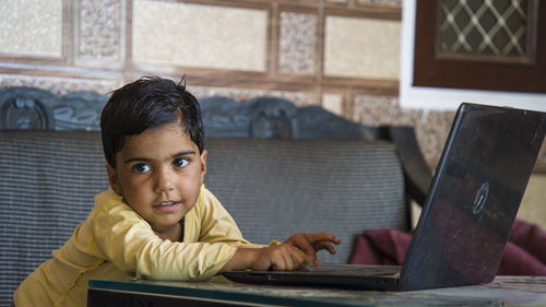 Cute girl using laptop at home