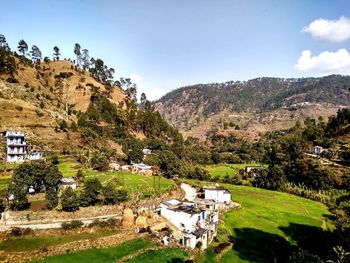 Scenic view of trees and buildings against sky