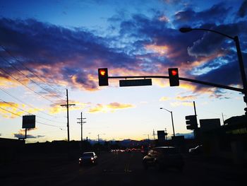 Traffic on road at sunset