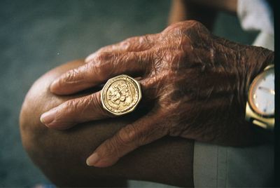 Close-up of hand holding coin against blurred background