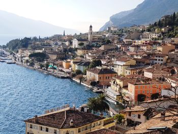 High angle view of townscape by sea against sky