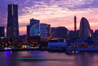 River with silhouette buildings against dusk