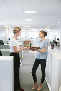 Young women talking in office