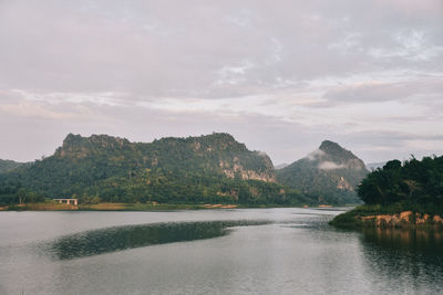 Scenic view of lake by trees against sky