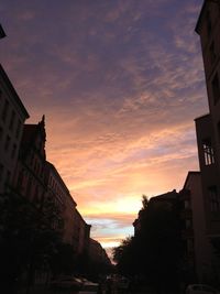 Low angle view of buildings against sky at sunset