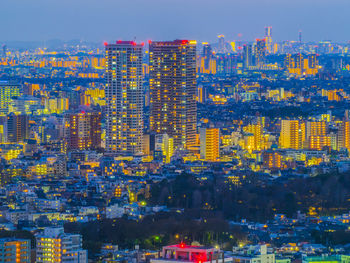 High angle view of illuminated cityscape against sky at night