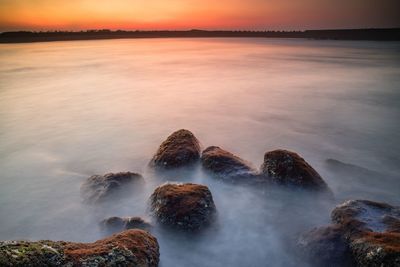 Scenic view of sea against sky during sunset