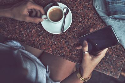 Midsection of person holding coffee cup