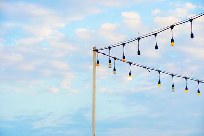 Low angle view of power lines against sky