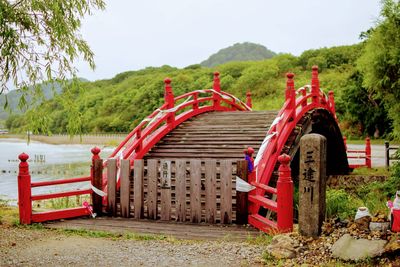 Built structure by river against sky