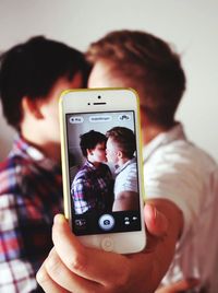 Midsection of man using mobile phone