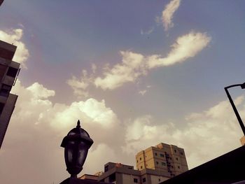Low angle view of building against cloudy sky