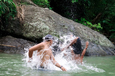 View of splashing water flowing in river