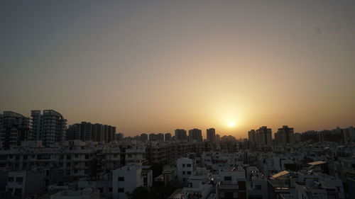 Cityscape against sky during sunset