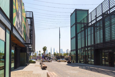 Street amidst buildings against sky in city