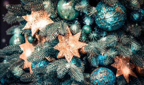 Different decorative christmas-tree toys close-up, decorations for christmas tree, spruce branch 
