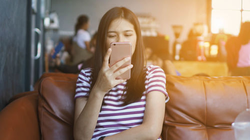 Midsection of woman using mobile phone