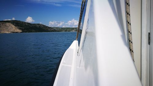 Sailboat sailing on sea against sky