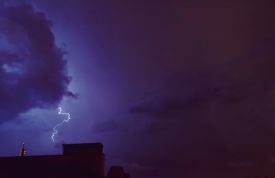 Low angle view of lightning against sky at night