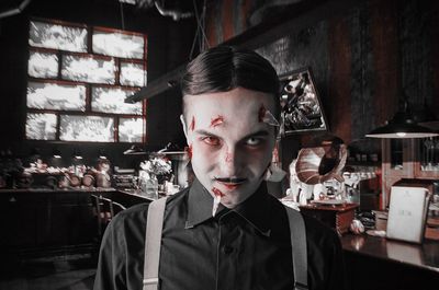 Portrait of young man standing in restaurant