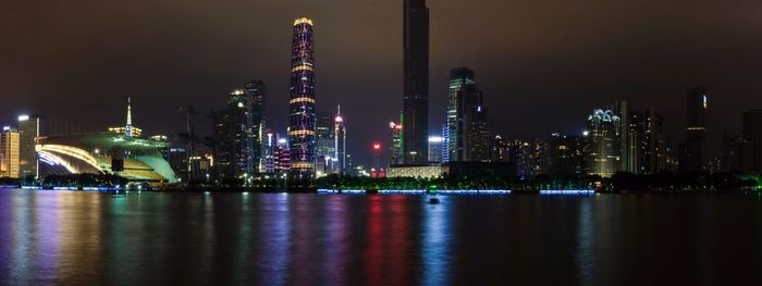 Illuminated city at waterfront