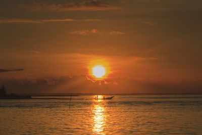 Silhouette of fisherman catching fish early in the morning at laem ta chi, pattani, thailand