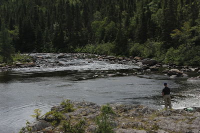 Rear view of man standing in water