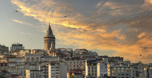 Cityscape of a part of istanbul city showing homes and galata tower at sunset