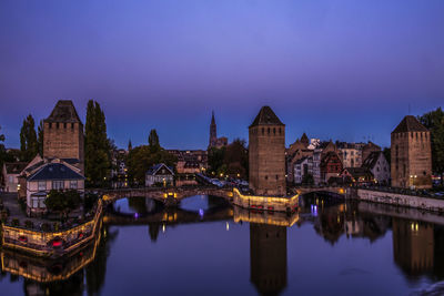 Reflection of buildings in water at night