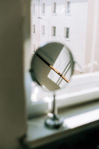 Close-up of electric lamp hanging on window