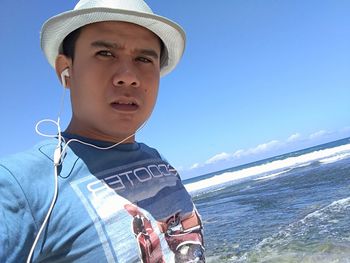 Portrait of boy in sea against sky