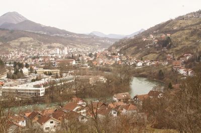 High angle view of townscape by lake in city