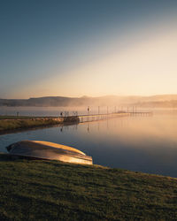 Scenic view of lake against sky during sunrise