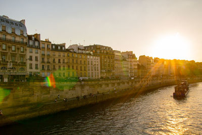 Buildings in city at sunset