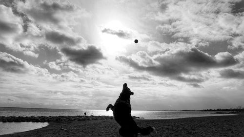 Man standing on beach against sky