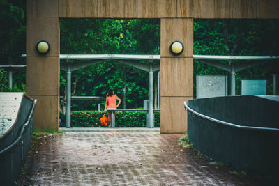 Woman standing by tree