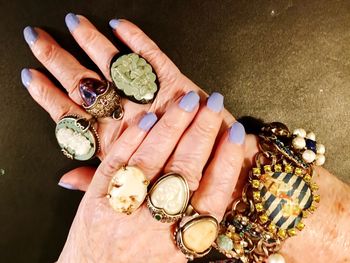 Close-up of woman holding ring on table