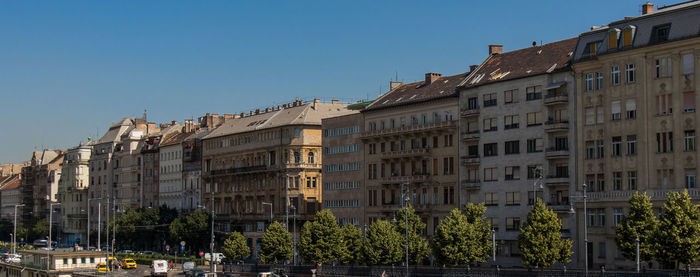 Low angle view of buildings against clear blue sky