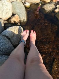 Low section of woman legs in water