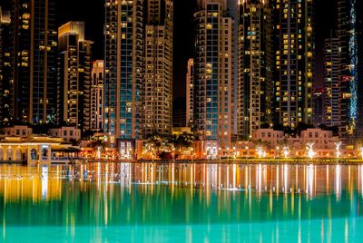 Reflection of illuminated buildings in water at night