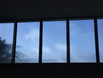 Low angle view of blue sky seen through window