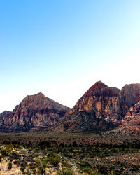 Scenic view of rocky mountains against clear blue sky