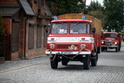 Vintage car on street against buildings in city