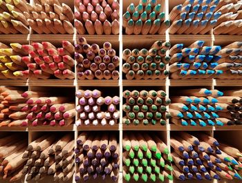 Close-up of multi colored pencils in shelf