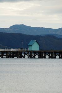 Scenic view of sea and mountains against sky