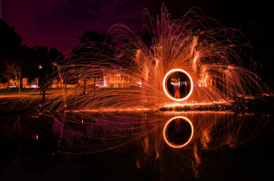 Low angle view of light trails at night