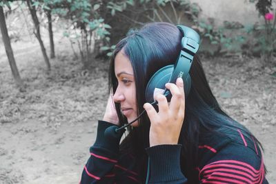 Close-up of young woman wearing headphones